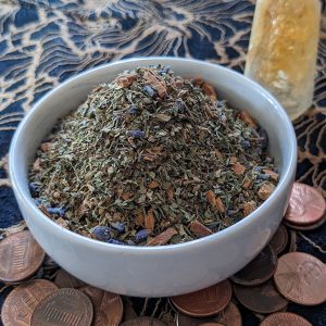 Lucky herbal blend in bowl with lucky pennies found on the street and citrine tower.