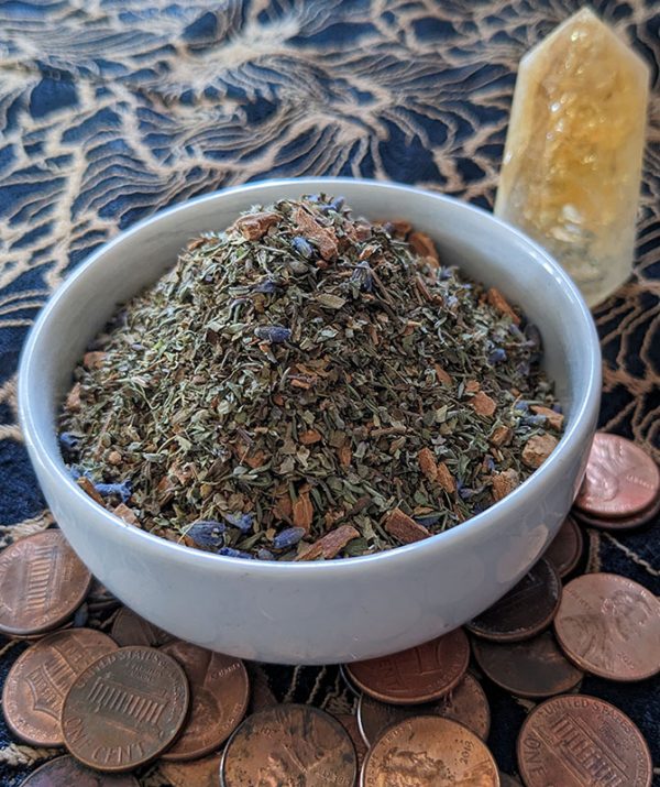 Lucky herbal blend in bowl with lucky pennies found on the street and citrine tower.