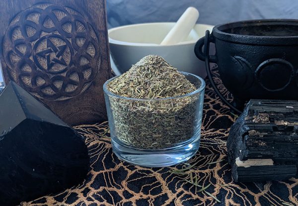 protection herbal blend with black obsidian, black tourmaline, pentagram box, triple moon caldron, and mortar and pestle.