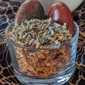 Good Health herbal blend in a bowl with Unakite and Red Jaspar palm stones.