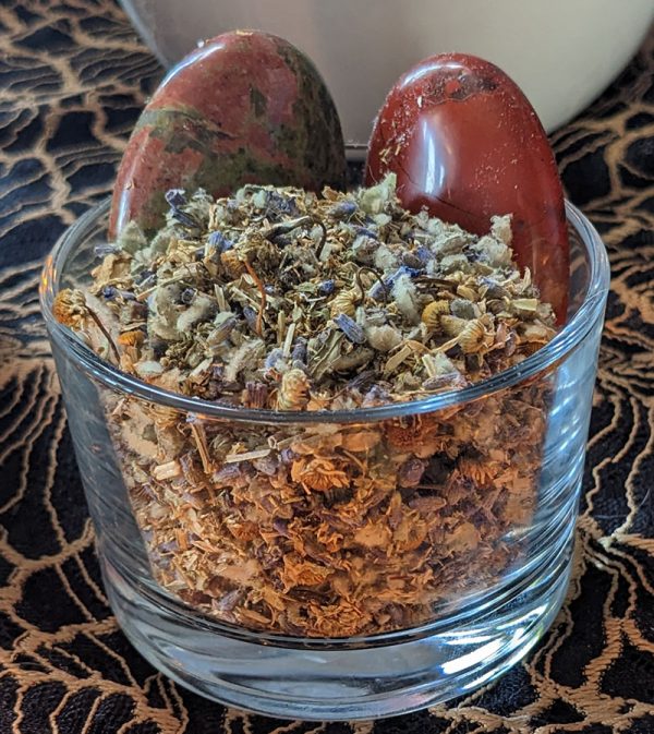 Good Health herbal blend in a bowl with Unakite and Red Jaspar palm stones.